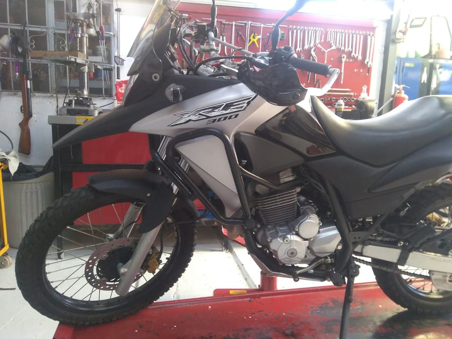 Moto en el elevador, pared de herramientas del taller
